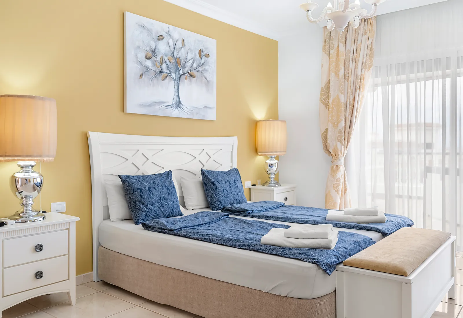 Doppelbett mit Nachttischlampen in Schlafzimmer 1 der Villa Alexander